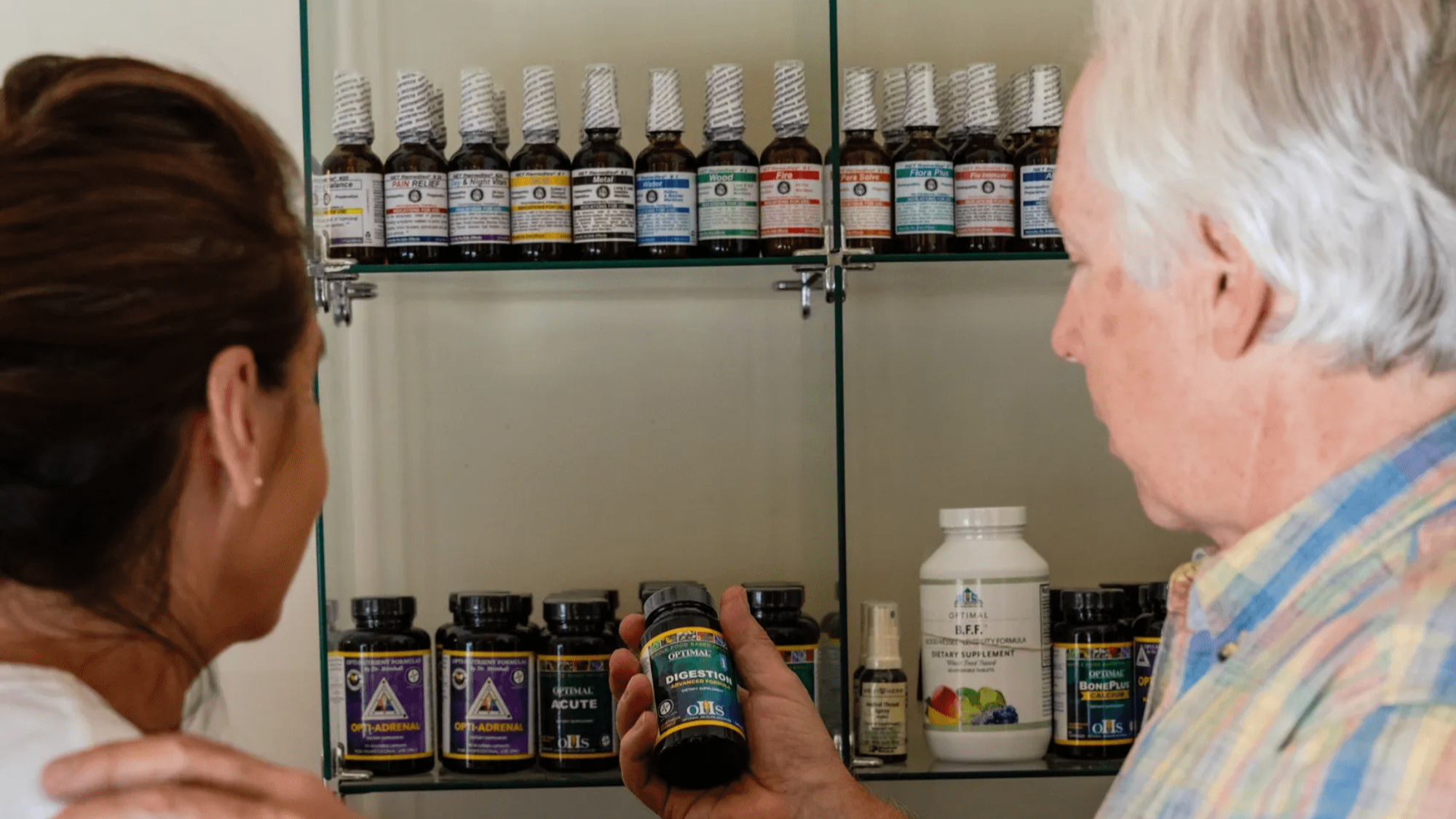 Dr. Tom showing patient supplements and vitamins for nutritional wellness in Basalt, CO